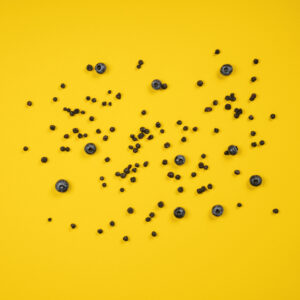 Gefriergetrocknete Blaubeeren auf gelbem Hintergrund
